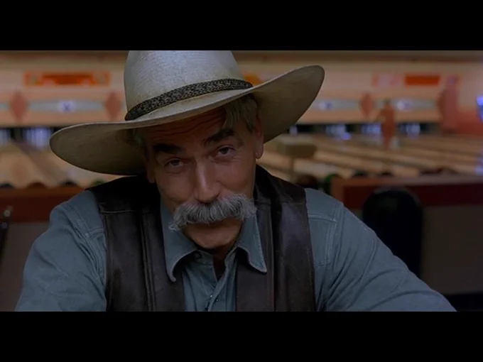 The Stranger, in close-up, is looking directly at the camera as he begins the movie's closing monologue.