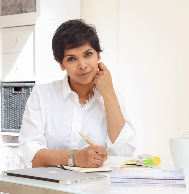 A photo of Goldie Putrym sitting at her desk. 
