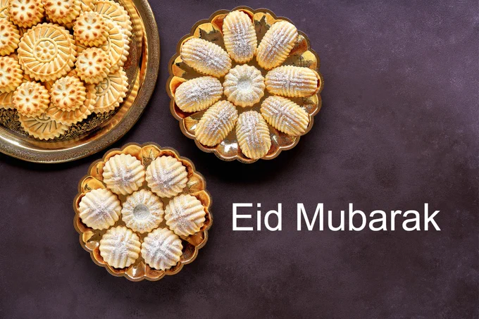 An image of sweet pastries with the text 'Eid Mubarak'
