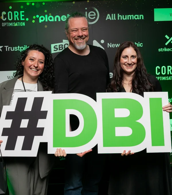Elodie Flenniau, Anthony Lindsay and Alison Visser hold a sign saying #DBI