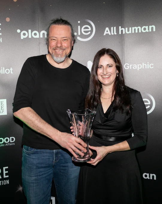 Anthony Lindsay and Alison Visser hold the glass trophy for Best New Website.