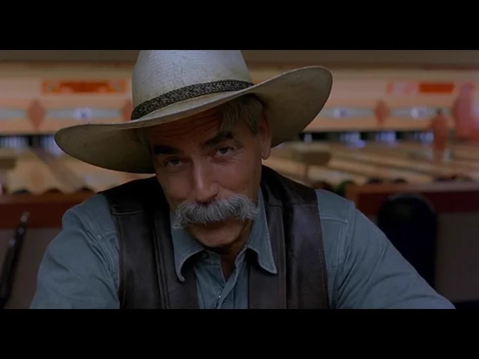 The Stranger, in close-up, is looking directly at the camera as he begins the movie's closing monologue.
