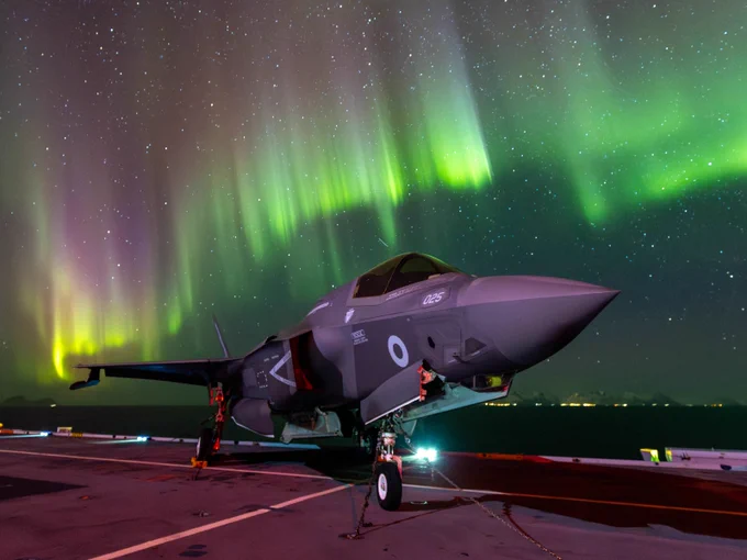Lightning on the ground with the Northern Lights in the sky above.