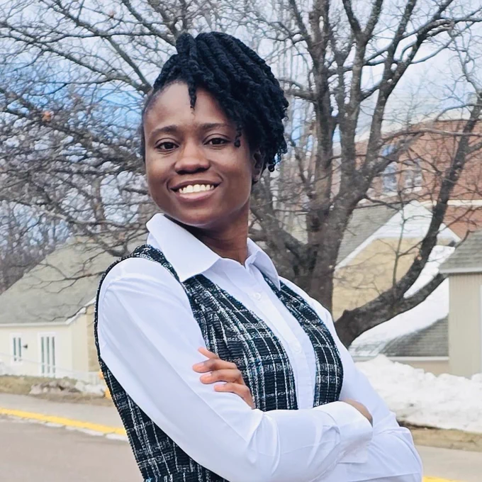 Photo of Oluwatosin Ayo outside with campus in background