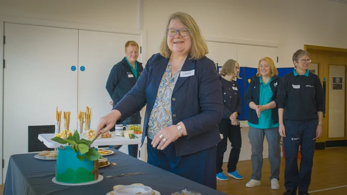Cabinet Member for Rural Affairs, Housing & Tourism, Cllr Sarah Burch cuts the celebration cake.