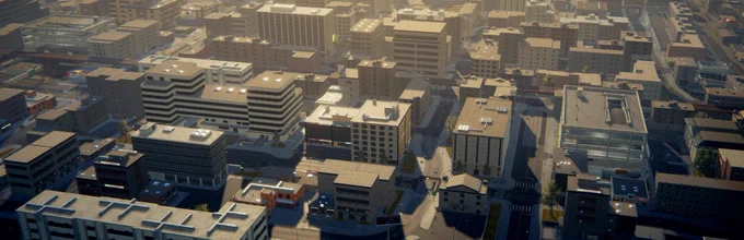 A screenshot from the game Flashing Lights, an aerial view of the city. Lots of buildings and some roads can be seen.