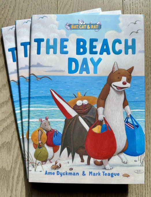 BAT, CAT & RAT #3: THE BEACH DAY, the follow-up to the Geisel Award-winning BAT, CAT & RAT #2: VACATION, by Ame Dyckman, Mark Teague, and the nice folks at Beach Lane Books, Simon & Schuster! In each picture book/early reader of 3-and-a-half stories, unlikely roommates-and-friends Bat, Cat, and Rat have funny little adventures in their cozy home, their cozy town, and beyond! THE BEACH DAY cover shows the trio carrying a beach umbrella and bags—TOO MANY bags, maybe?—for a fun day in the sand and surf. (But poor sweet Bat doesn’t know that trying to share your snack with hungry beach gulls is NOT a good idea! OOPS!) Available NOW for preorder wherever you love to get books, and publishes 4/29/25!