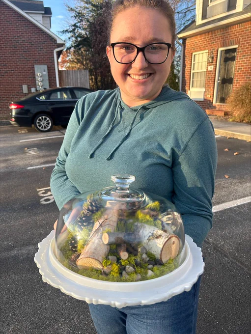 EPP master's student Rebecca Horn holding a handmade insect-dome.