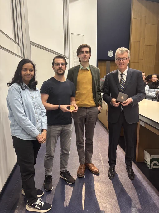 OSC members Sagarika, Saban, and Thomas (left to right) meeting Prof. Sir David MacMillan (right).