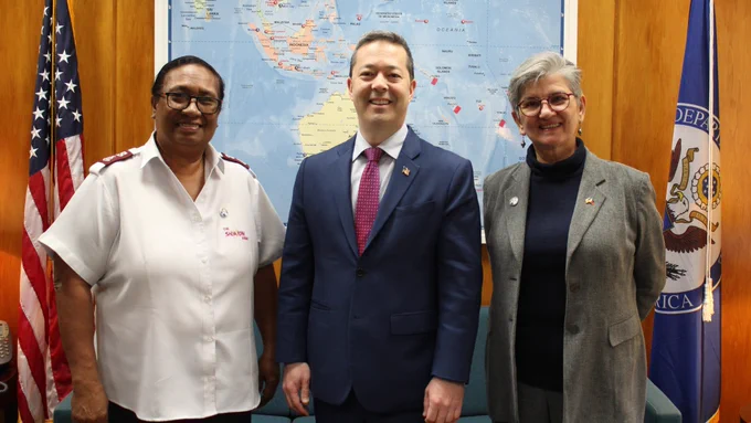 IWOC Awardee Major Velena Iga of Papua New Guinea, Senior Bureau Official Sean O'Neill, and IWOC Awardee Angelique Songco of the Philippines pose for a photo.