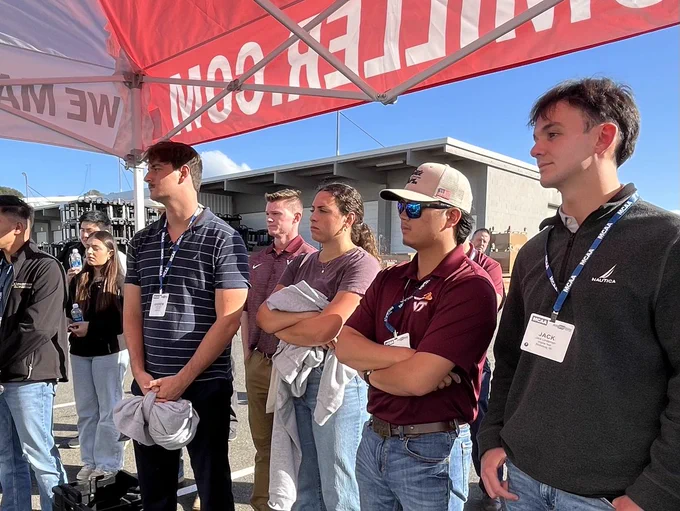 Photo of students under a tent. 
