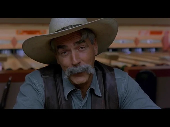 The Stranger smiles as he continues to deliver the movie’s closing monologue.