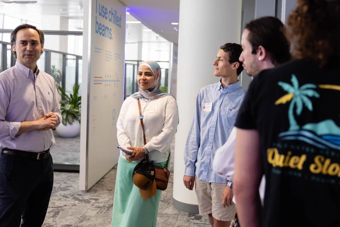 Photo of the team listening to an employee. 