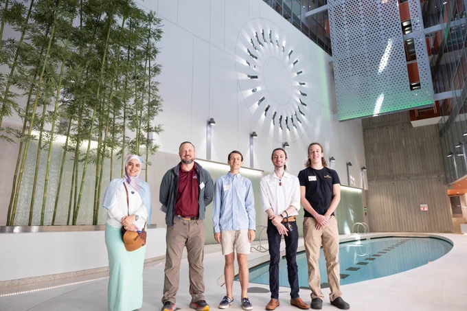 Photo of the team in front of a pool.