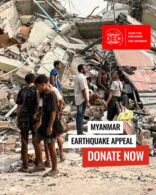 Poster for the Myanmar Earthquake Appeal showing individuals standing amid extensive rubble, urging donations to Save the Children, a DEC member.