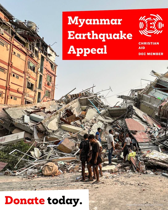 Image: People stand past the debris of a collapsed building in Mandalay, Myanmar, on 28 March 2025 after the earthquake. Overlaid is the text "Myanmar Earthquake Appeal" with the DEC logo next to it. At the bottom the text reads "Donate today".