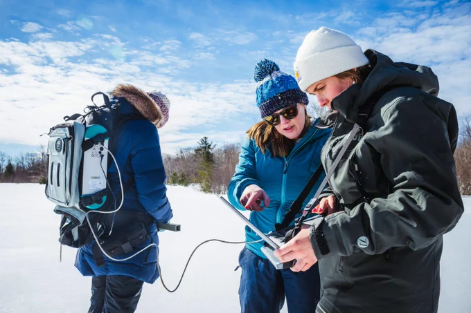 Assistant Professor Alden Adolph, center, makes the most of Tech’s snowy locale by conducting snow albedo research at a local field site.
