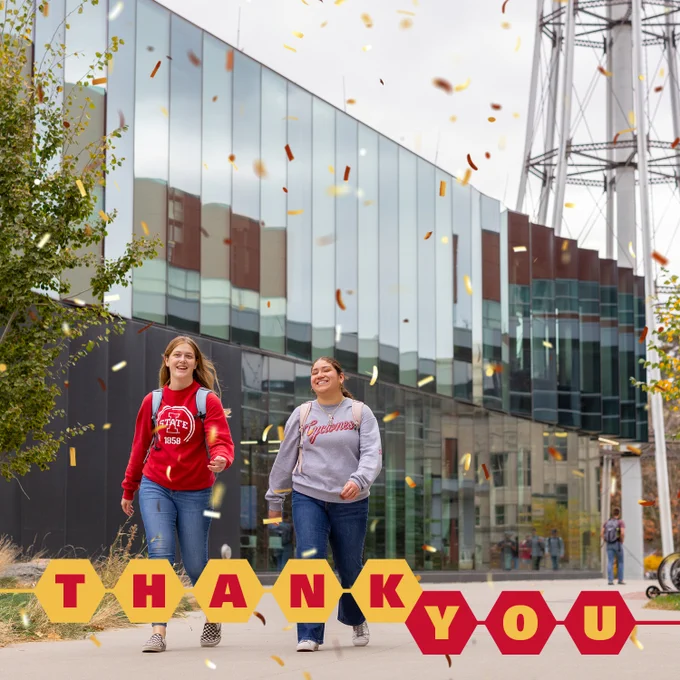 Two students walking and smiling outside a modern building. Falling confetti is overlaid on the image, with a banner that reads "Thank you"