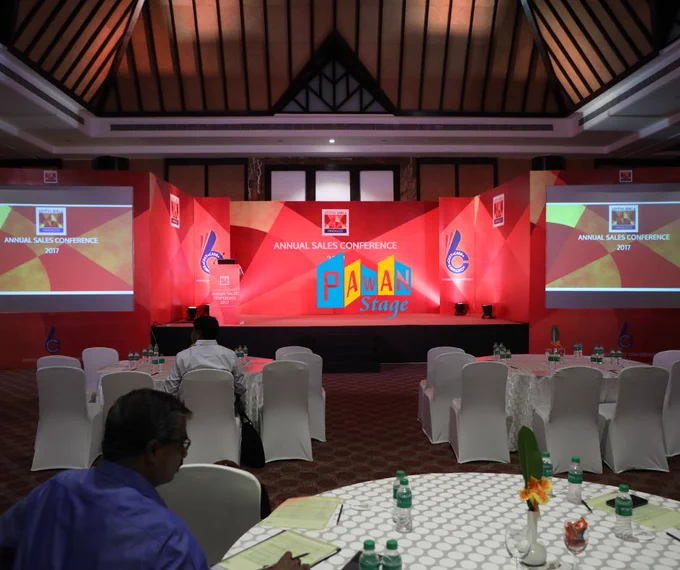 Conference room in Ananta Udaipur, equipped with tables and chairs arranged for a corporate presentation event.