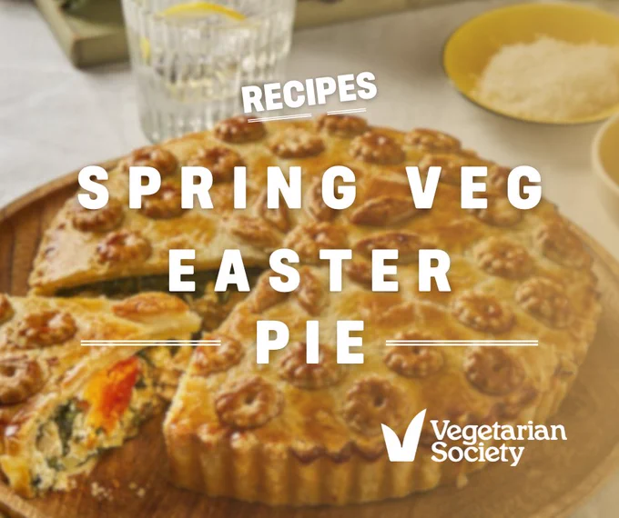 A blurred background of an easter pie, with white writing reading 'RECIPES - SPRING VEG EASTER PIE'. The Vegetarian Society logo in white is in the bottom right corner.