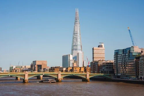 View of the Shard, London, from the River Thames, surrounded by cranes & buildings of concrete, steel & glass - other than the river, the perfect ingredients for creating an urban heat island, where the concrete, steel & glass absorb the heat during the day & release it slowly at night. During heat waves, the effect of this is unbearable.
