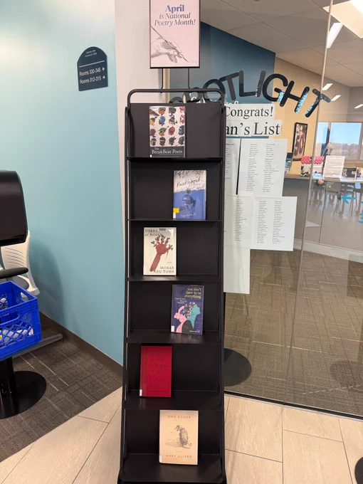 Vertical book display with books of poetry.
