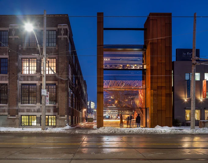 Exterior view of Gusto 501 at night.