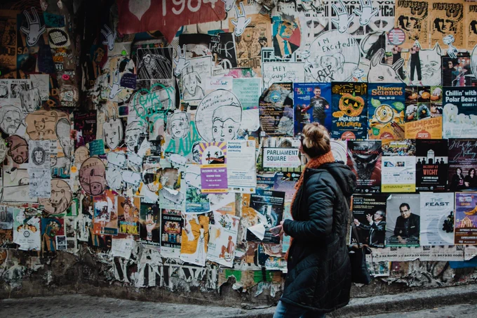 This image shows a woman looking at a wall covered in tattered old advertising posters.

The post says:

I recently read “What If We Made Advertising Illegal?“ (https://simone.org/advertising/). It makes a bold case: advertising is corrosive, manipulative, and ultimately harmful to society. It fuels attention-hijacking, undermines truth, and distorts our shared reality. As with other once-tolerated hazards—lead in paint, indoor smoking—perhaps it’s time we called time on advertising altogether.

But what if, rather than banning it outright, we taxed it instead?
https://matthewsinclair.com/blog/0177-what-if-we-taxed-advertising