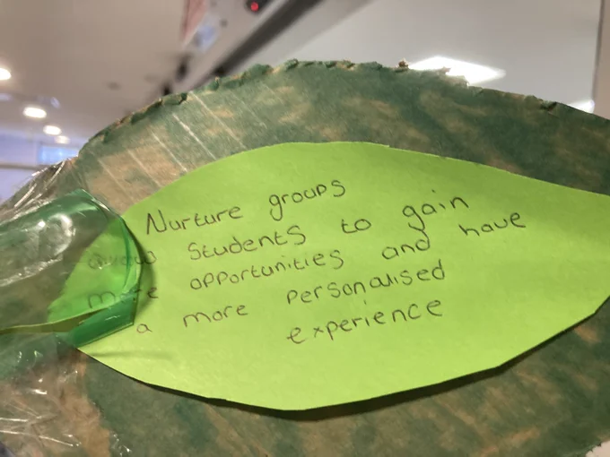 A green card leaf with a handwritten message on