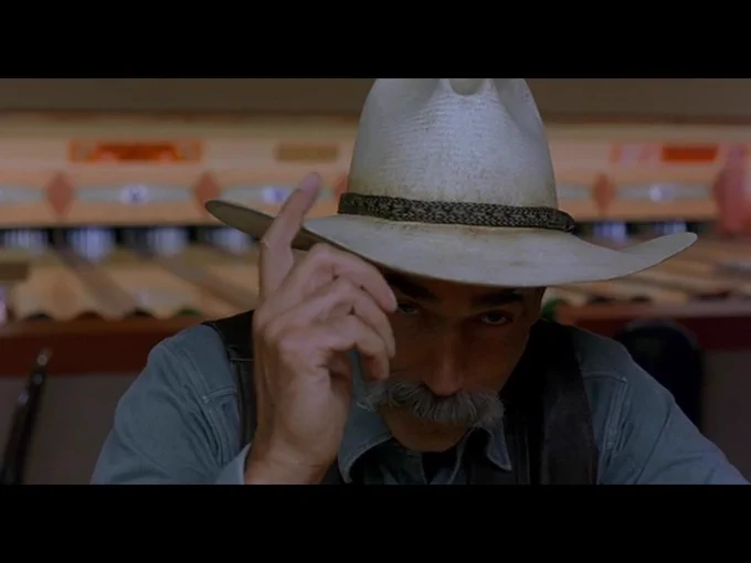 The Stranger tips his hat at the viewer as he signs off to close the movie.