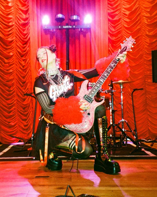 Michelle Lambert performing on stage with a t-shirt that has the new Giants City Connect script