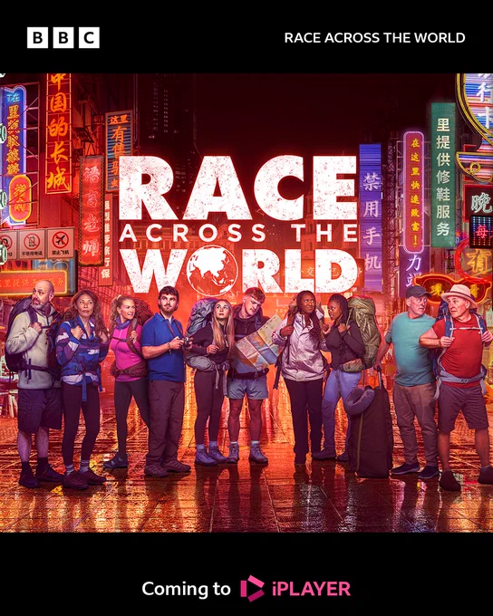 Artwork for Race Across The World 2025. Ten contestants stand on an empty city street at night. Many carry large rucksacks, while some have maps, cameras, or other luggage. They all look around at their surroundings. The street is illuminated by lots of neon signs. Text at the bottom of the image reads: “Coming to iPlayer.”