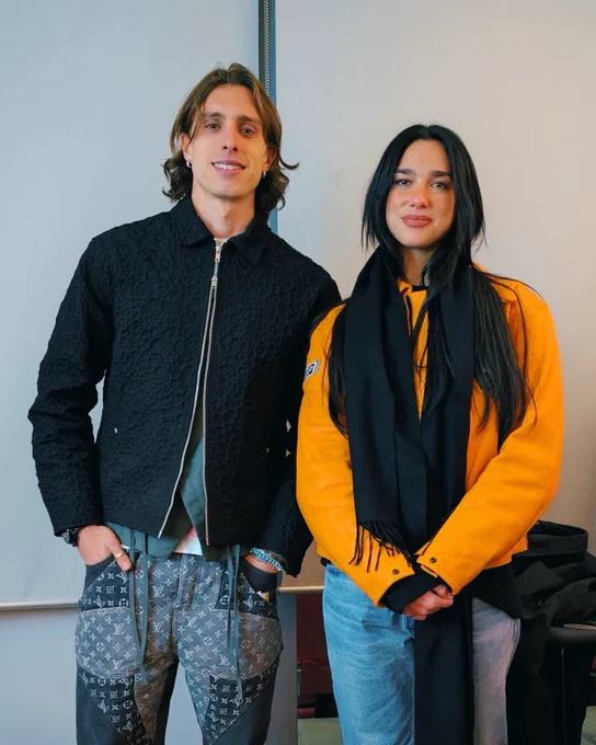 Riccardo Calafiori and Dua Lipa pose for a photo at Arsenal Stadium.