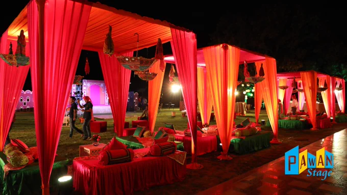 Outdoor decoration at Taj Aravali Resort, Udaipur, featuring elegant red and green drapes for a  corporate gala night theme.