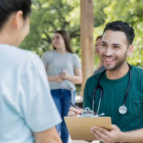 Smiling healthcare professional with a clipboard 