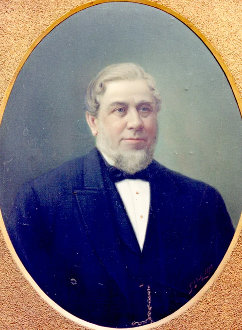 Portrait of John Hughes in formal attire.