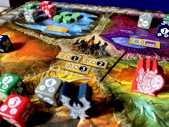 The board game Shadow Kingdoms of Valeria. The picture is zoomed in on the center of the board and focused on the Shrine of the Titans. Dice, meeples and other tokens surround the shrine