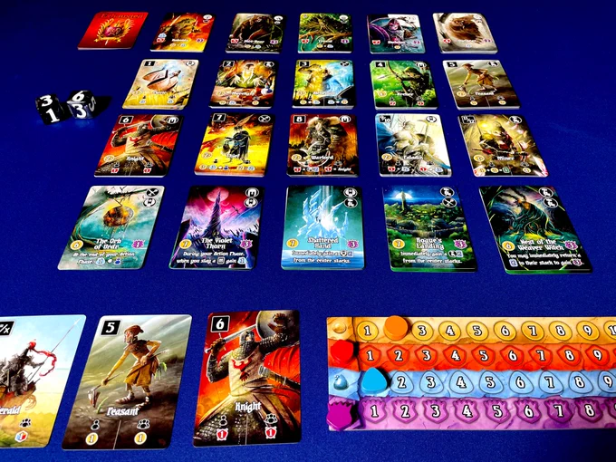 The card game Valeria Card Kingdoms all set up! There is a player board to track resources, some starting cards like a Knight and Peasant, 4x5 stacks of cards, and two dice