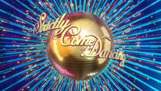 A gold glitterball emits rays of sparkling reflected light across the blue background. Strictly Come Dancing is written in gold cursive writing.