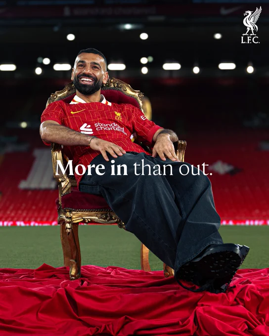 Mo Salah sat on a throne at Anfield to announce he has signed a new contract. The text says 'more in than out' 