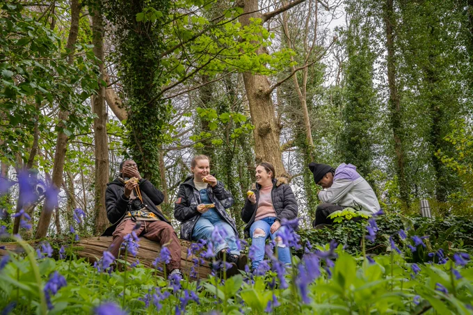 People sat talking and laughing in forest. Credit: Ben Lee WTML