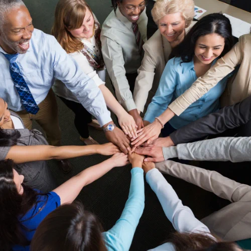 A group of professionals in a group huddle.