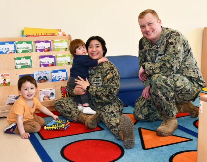 Three-year-old Philip Scott, one-year-old James Scott, Electrician’s Mate (Nuclear) Anh Scott and Electrician’s Mate (Nuclear) First Class Michael Scott have been a military family since the birth of Philip Scott.