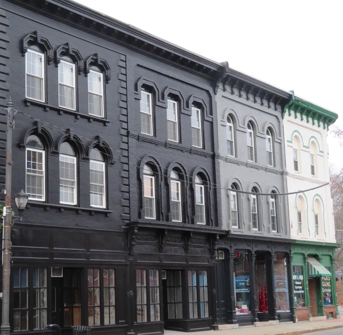 Picture of townhouses, each painted in a shade from black to white, showing a grayscale effect