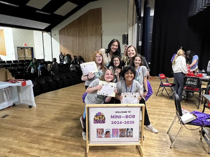 Students won third place at the battle of the books pose for a picture.