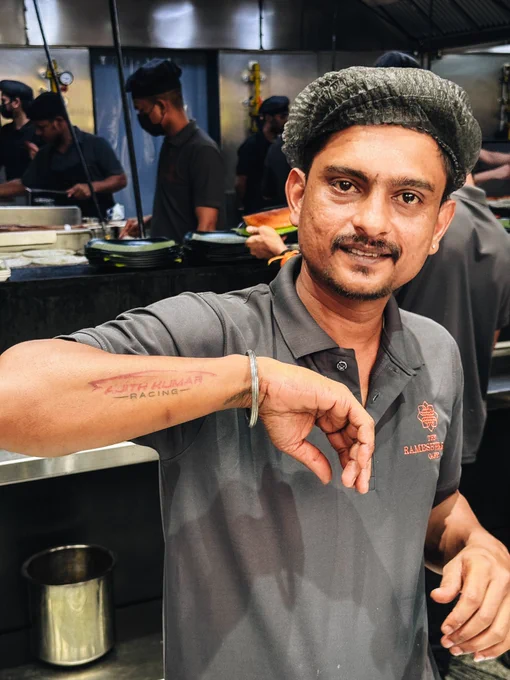 Picture of a staff adorning the ‘Ajith Kumar Racing’ tattoo.