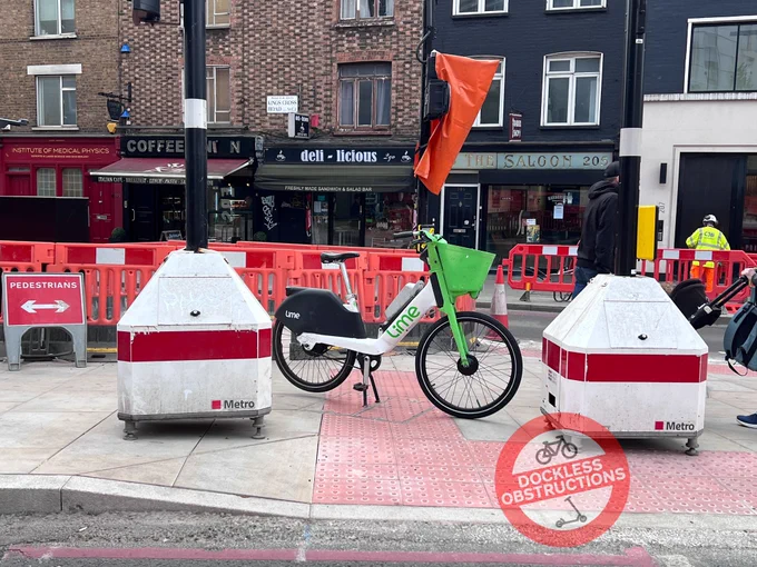 Lime bike parked on pedestrian crossing.