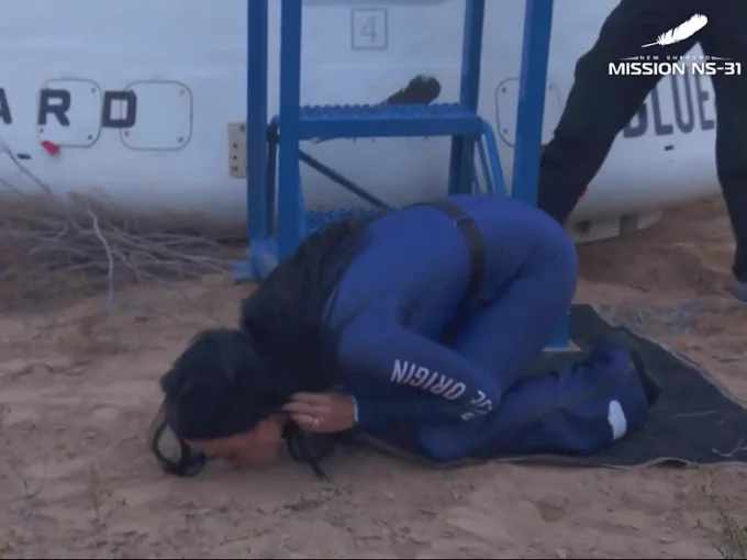 Katy Perry kissing the ground.