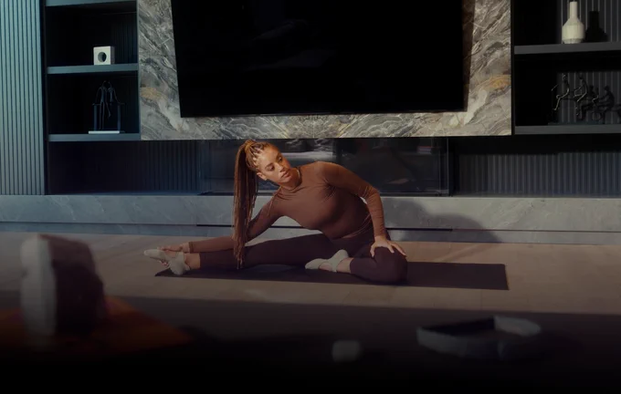 Women doing yoga after session with Muse S Athena headband in modern apartment