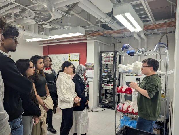 Students listen to Prof. Sanfeng Wu touring his lab